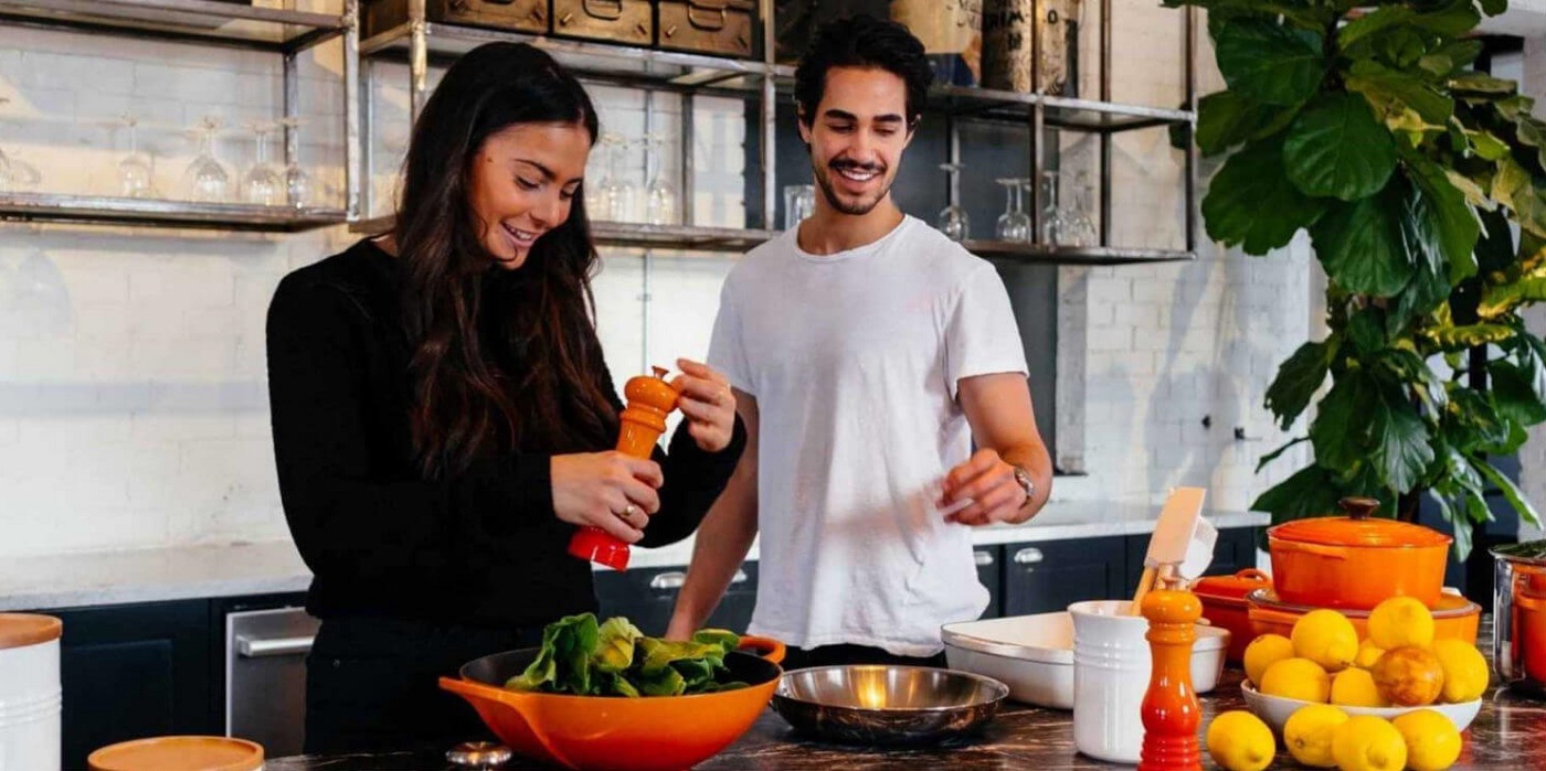 Couple cooking and smiling